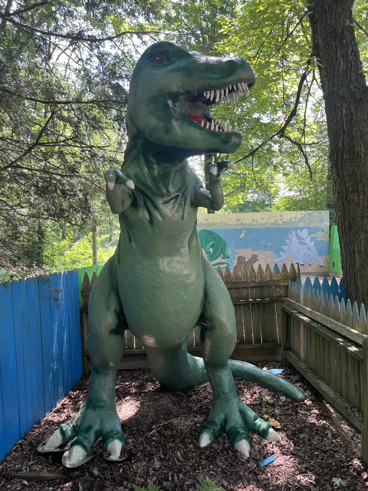a green statue of a dinosaur